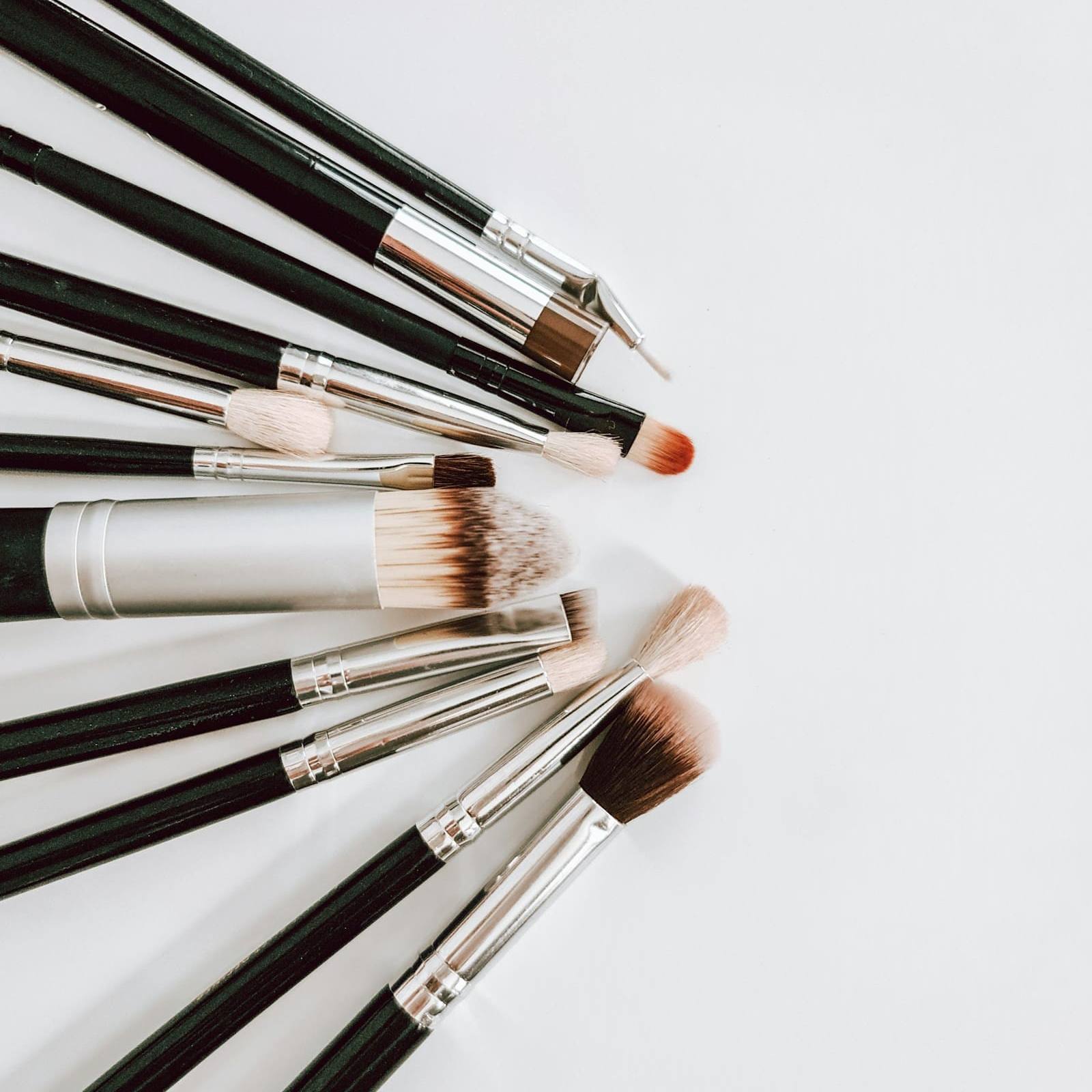 Fan of make-up brushes on a white surface